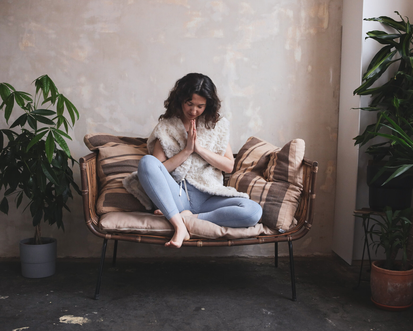 Yael seated peacefully between plants